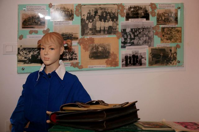 Old school uniform and school photographs on display